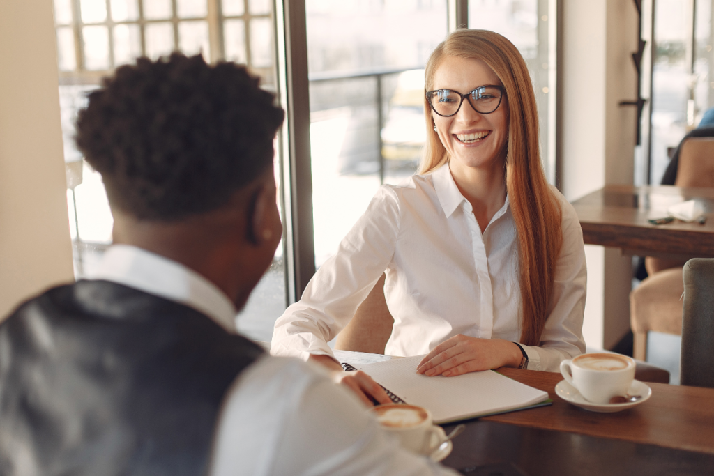 Leader and employee at a table discussing PTO request.