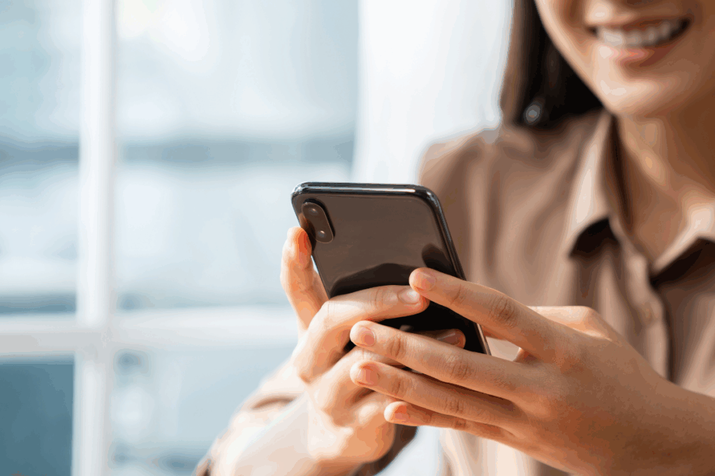 Woman smiling and scrolling on phone