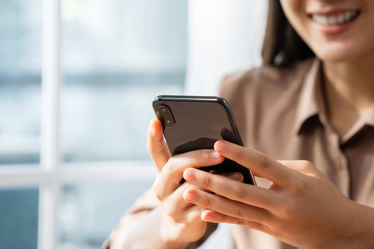 Woman smiling and scrolling on phone